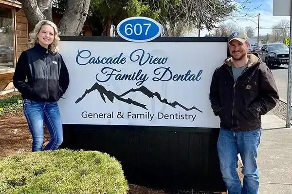 The staff at Cascade View Family Dental standing in front of practice's sign